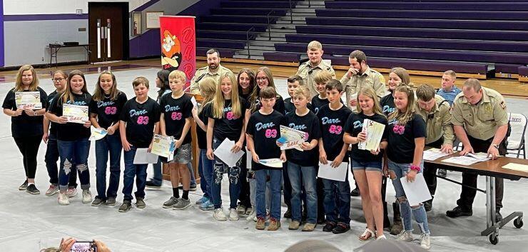 A class of students holding D.A.R.E certificates.