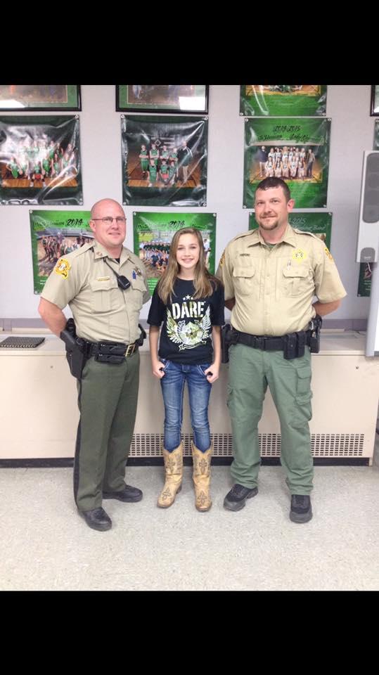Deputy Hawkins standing next to a woman and another deputy.